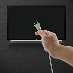 Hand pulling television plug